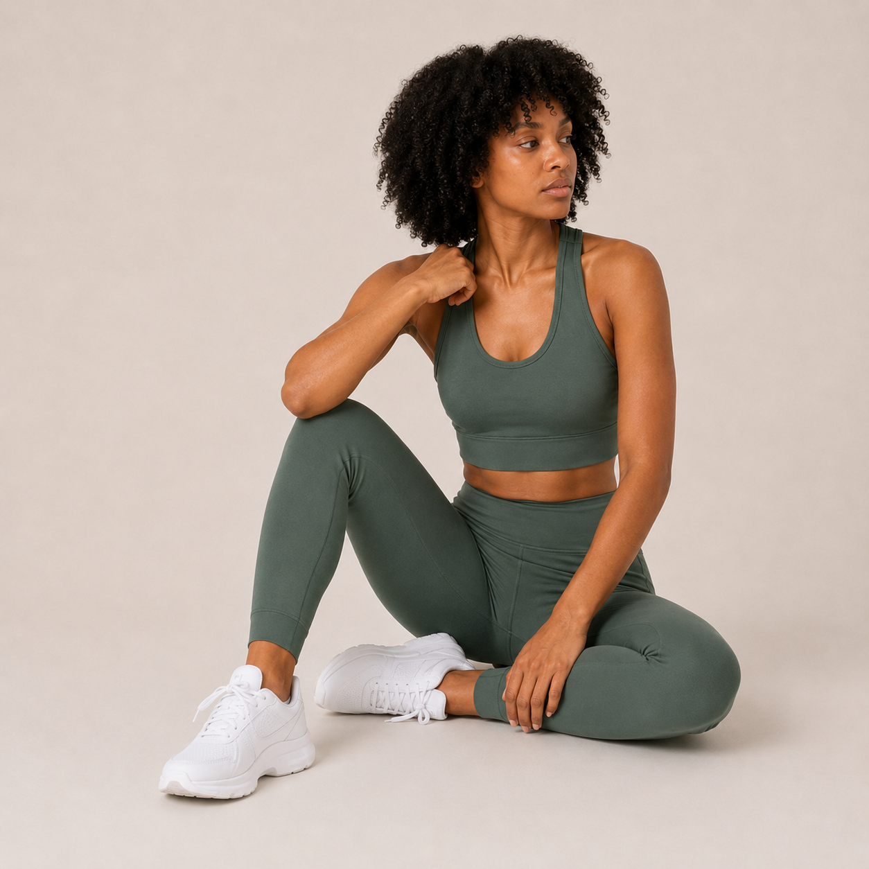 Model seated in the Fitfigura Seamless Set – Performance Sculpt Form in sage green, showing the supportive fit and soft activewear styling.