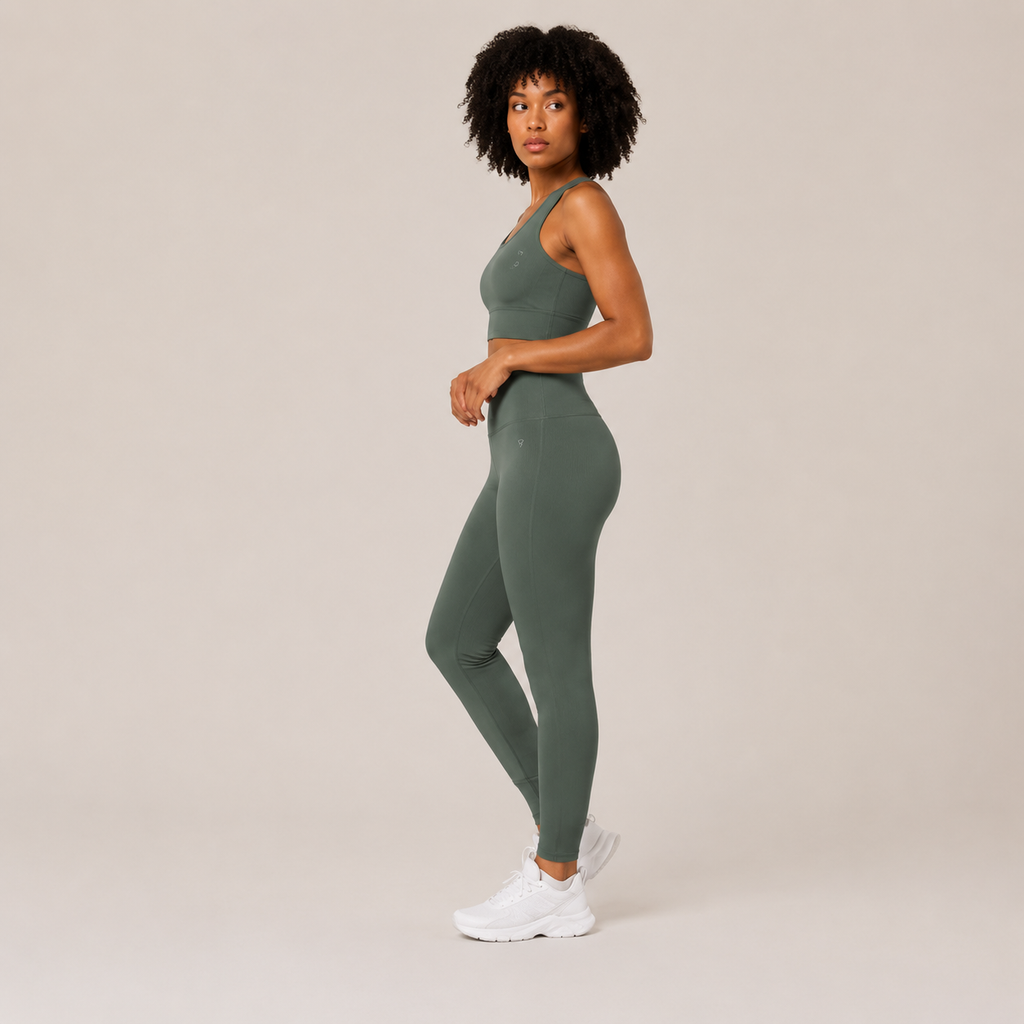 Side view of the Fitfigura Seamless Set – Performance Sculpt Form in sage green, showing the sleek fitted leggings and cropped top silhouette.