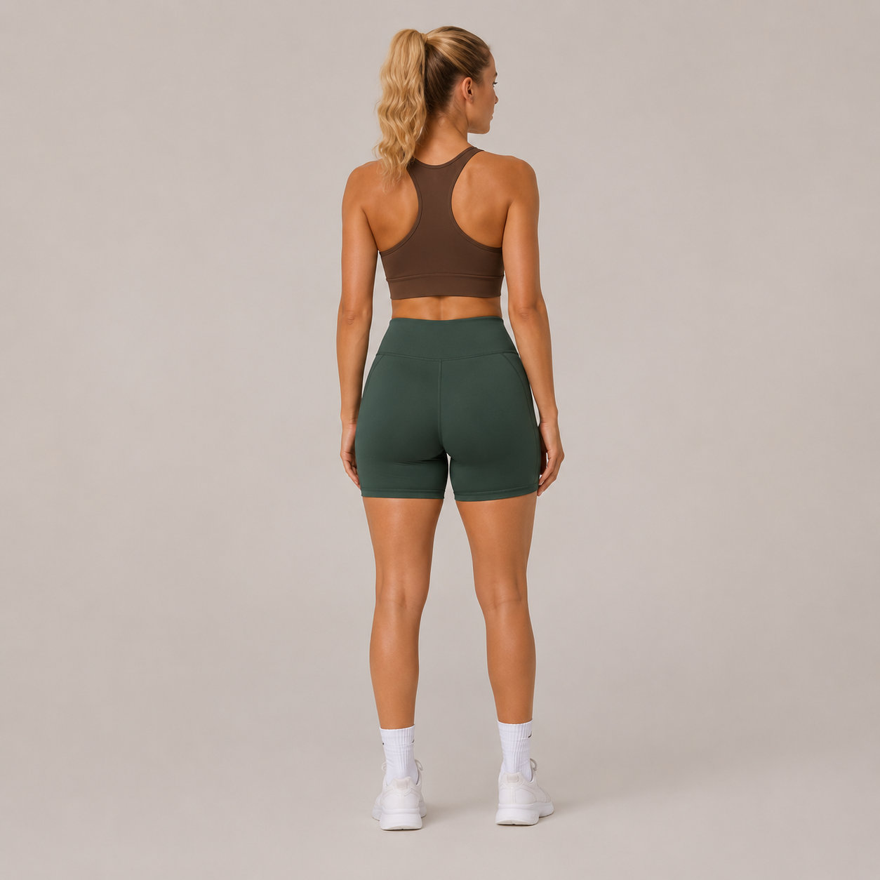 Back view of the dark green Fitfigura Seamless Short – Athletic Form, showing the high-rise waistband and fitted rear silhouette.