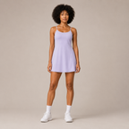 Model wearing the Fitfigura Serve Dress – Elite Court Form in light purple with white socks and white sneakers, shown from the front.