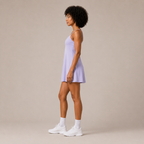 Side view of the Fitfigura Serve Dress – Elite Court Form in light purple, showing the sleeveless cut and softly flared dress shape.