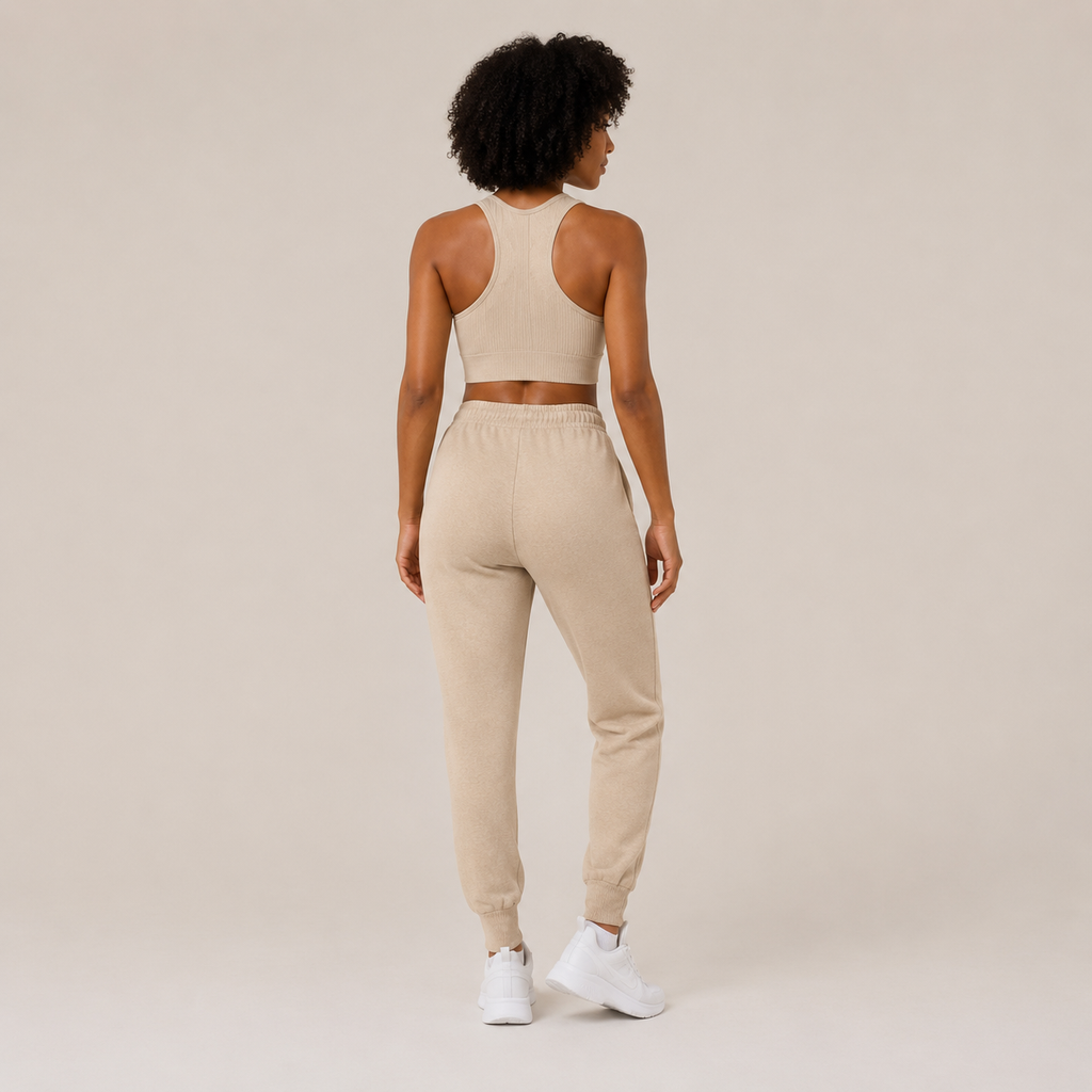 Back view of the Fitfigura Soft Ribbed Set – Luxe Comfort Form in cream, showing the rear fit of the crop top and jogger pants.