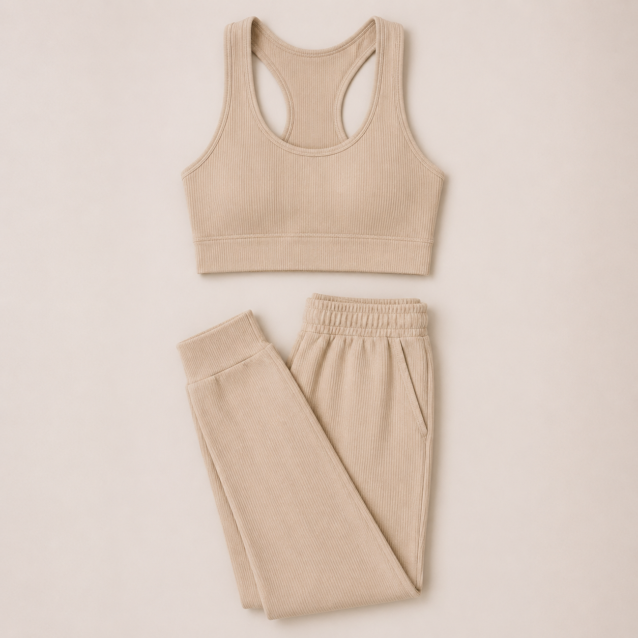 Flat lay of the Fitfigura Soft Ribbed Set – Luxe Comfort Form in cream, featuring a sleeveless crop top and matching jogger pants.