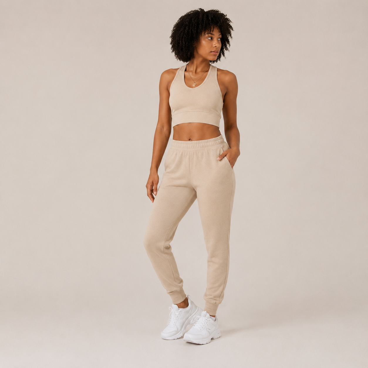 Full-body studio view of the cream Fitfigura Soft Ribbed Set – Luxe Comfort Form, showing the coordinated crop top and jogger pants.