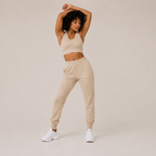 Model posing in the cream Fitfigura Soft Ribbed Set – Luxe Comfort Form with arms raised, highlighting the soft ribbed texture and relaxed fit.