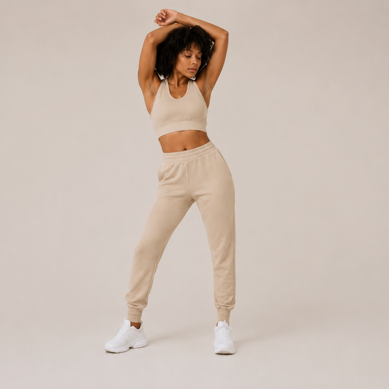 Model posing in the cream Fitfigura Soft Ribbed Set – Luxe Comfort Form with arms raised, highlighting the soft ribbed texture and relaxed fit.