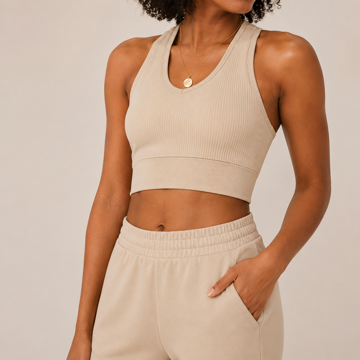 Close-up of the cream Fitfigura Soft Ribbed Set – Luxe Comfort Form showing the sleeveless crop top, neckline, and ribbed fabric texture.