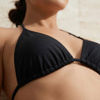 Close-up of the black Fitfigura Strap Bikini – Minimal Form showing the bikini top, neckline, and minimal strap styling.