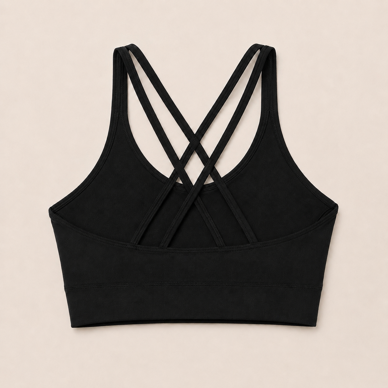 Flat lay back view of the Fitfigura Studio Bra – Soft Flow in black, highlighting the crisscross strap detail.