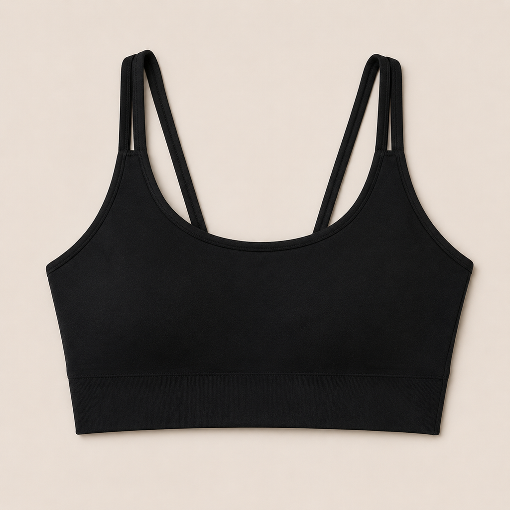 Flat lay front view of the black Fitfigura Studio Bra – Soft Flow, showing the scoop neckline, slim straps, and structured bra shape.