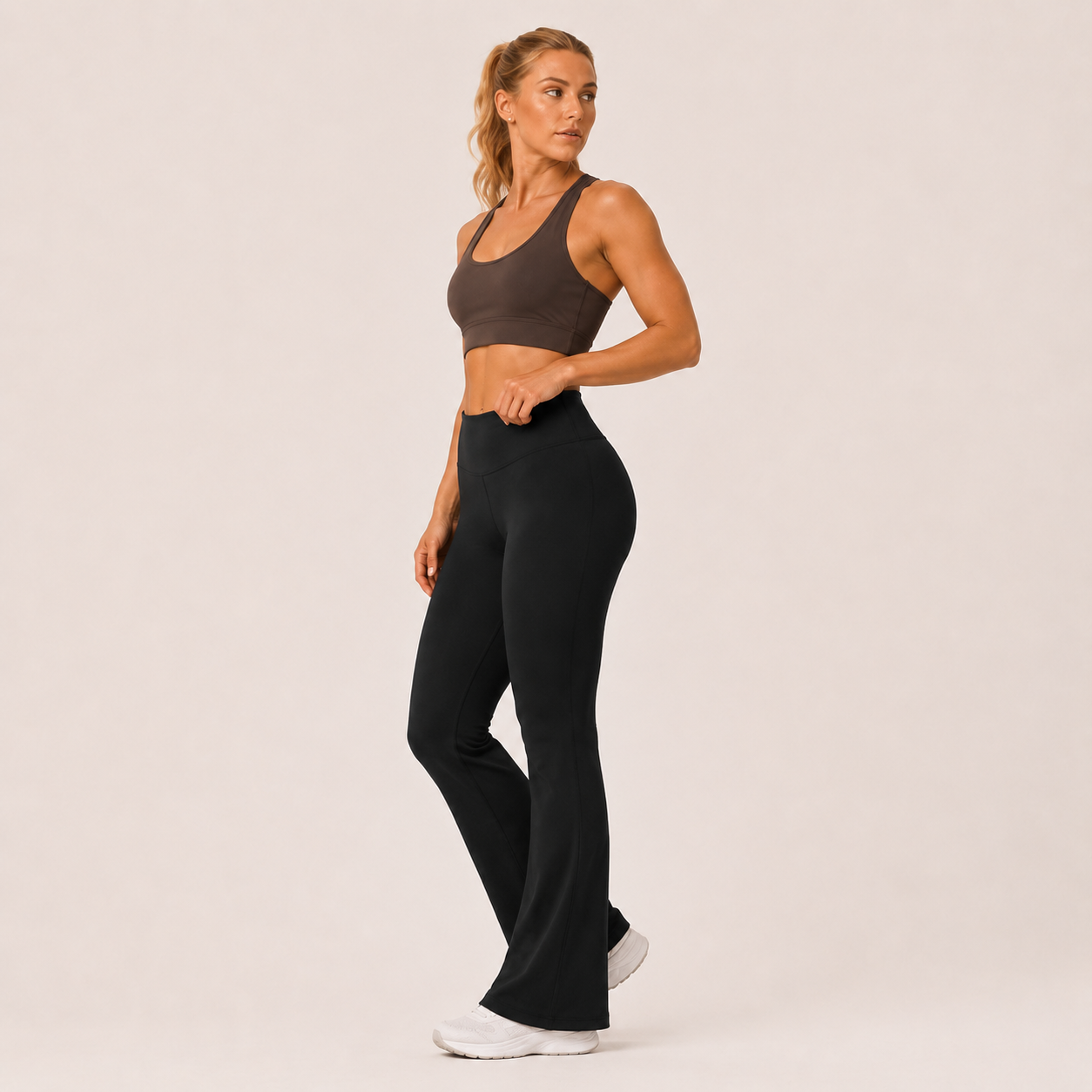 Side-angle view of the black Fitfigura Studio High Waist Flare Pant – Fluid Motion Form, showing the smooth fit through the hips and the flared leg shape.