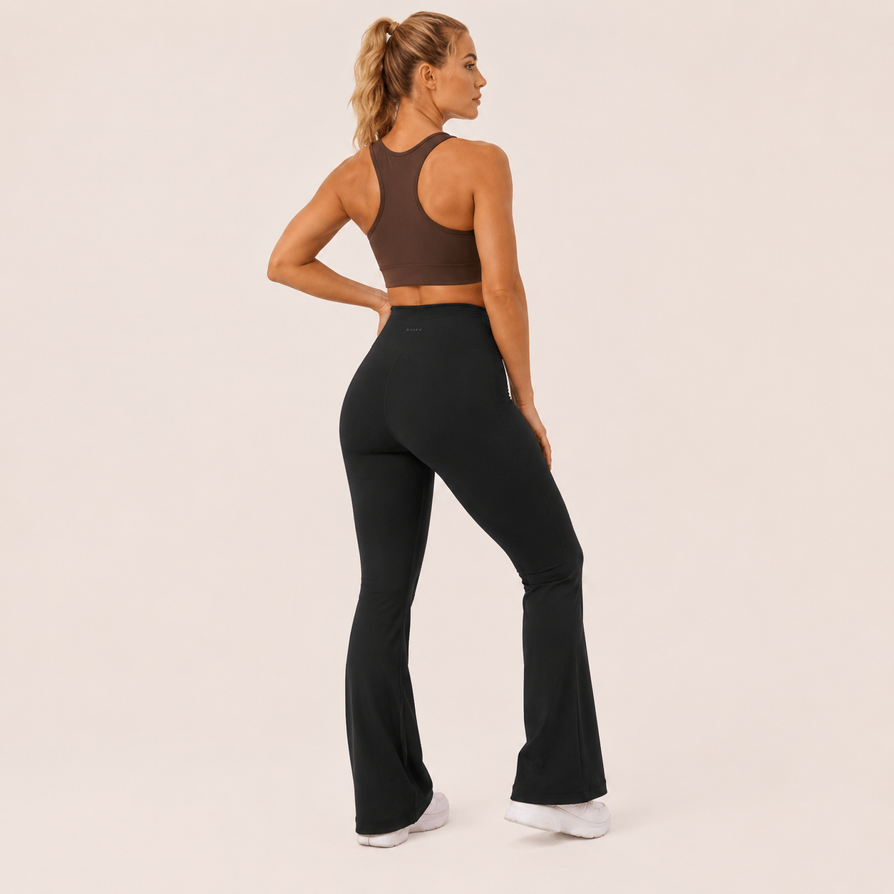 Three-quarter view of the black Fitfigura Studio High Waist Flare Pant – Fluid Motion Form, highlighting the contoured fit and flared hemline.