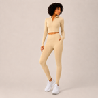 Angled studio view of the cream Fitfigura Studio Set – Soft Flow Form, highlighting the slim fit and clean activewear styling.