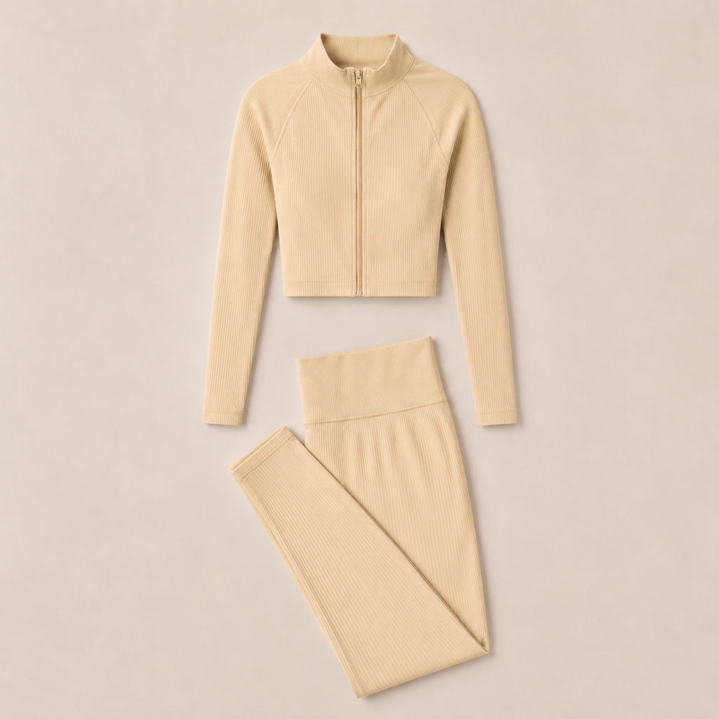 Flat lay of the Fitfigura Studio Set – Soft Flow Form in cream, featuring the zip-front long sleeve top and matching leggings.