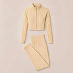 Flat lay of the Fitfigura Studio Set – Soft Flow Form in cream, featuring the zip-front long sleeve top and matching leggings.
