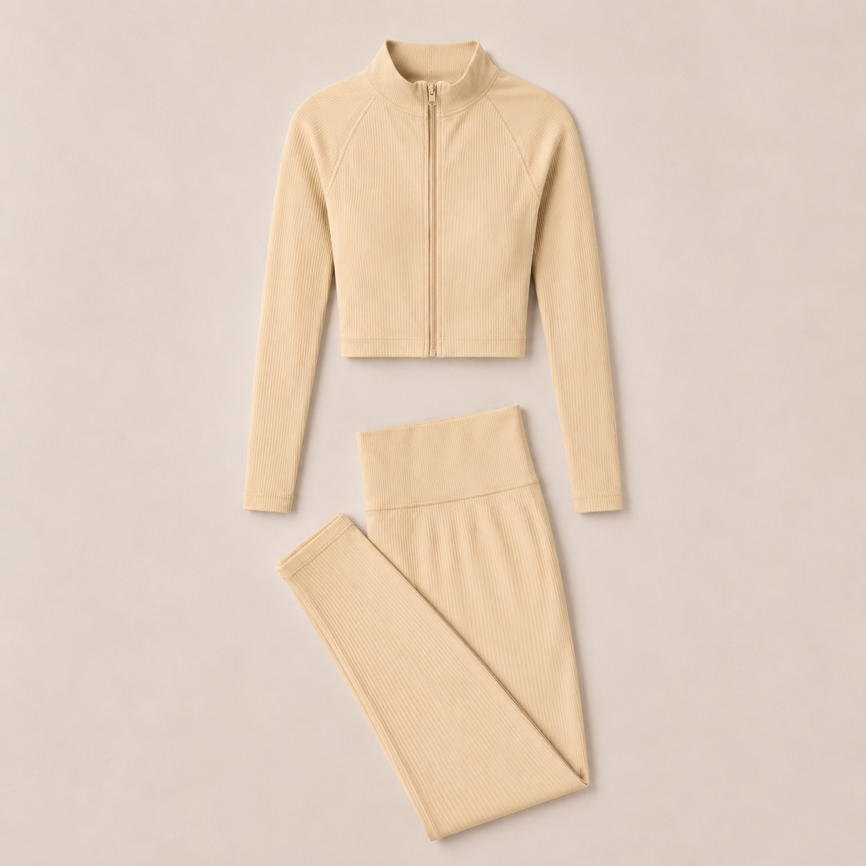 Flat lay of the Fitfigura Studio Set – Soft Flow Form in cream, featuring the zip-front long sleeve top and matching leggings.