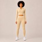Model wearing the Fitfigura Studio Set – Soft Flow Form in cream, featuring a zip-front long sleeve crop top and matching leggings, shown from the front.