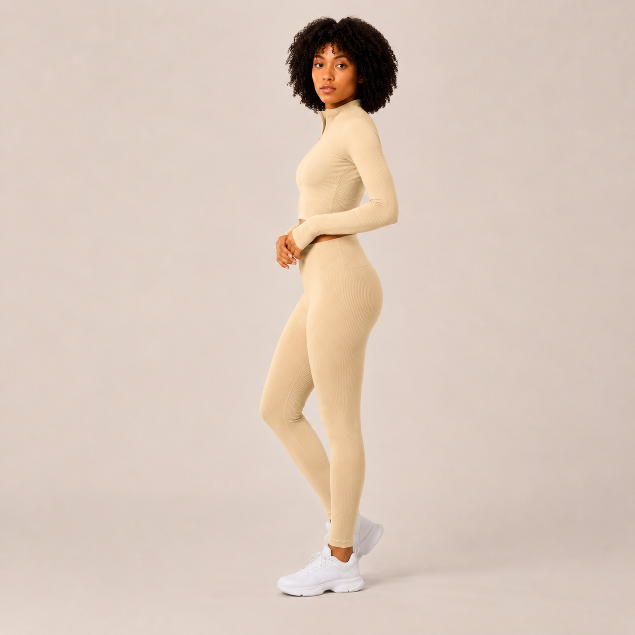Side view of the cream Fitfigura Studio Set – Soft Flow Form, showing the fitted leggings and cropped long sleeve top.