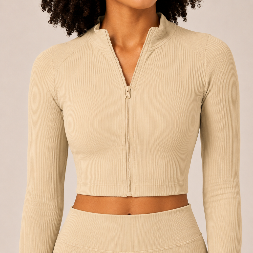 Close-up of the cream Fitfigura Studio Set – Soft Flow Form showing the zip-front crop top, collar, and soft fitted fabric.