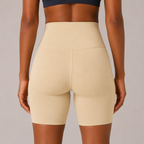 Close-up back view of the cream Fitfigura Studio Short 8” – Flow Essential Form, highlighting the waistband and supportive fit.