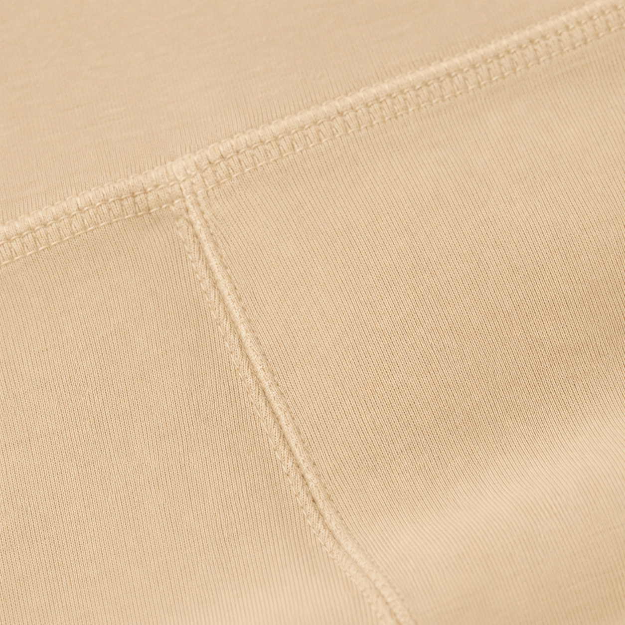 Close-up of the cream fabric and seam detail used in the Fitfigura Studio Short 8” – Flow Essential Form.