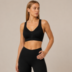 Model wearing the Fitfigura Support Bra – Stability Form in black with matching leggings, showing the V-neckline and supportive front fit.