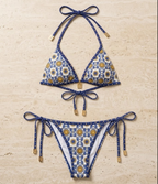 Flat lay of the Fitfigura Triangle Bikini – Classic Form in blue patterned print, featuring a tie-neck triangle top and matching tie-side bikini bottoms.