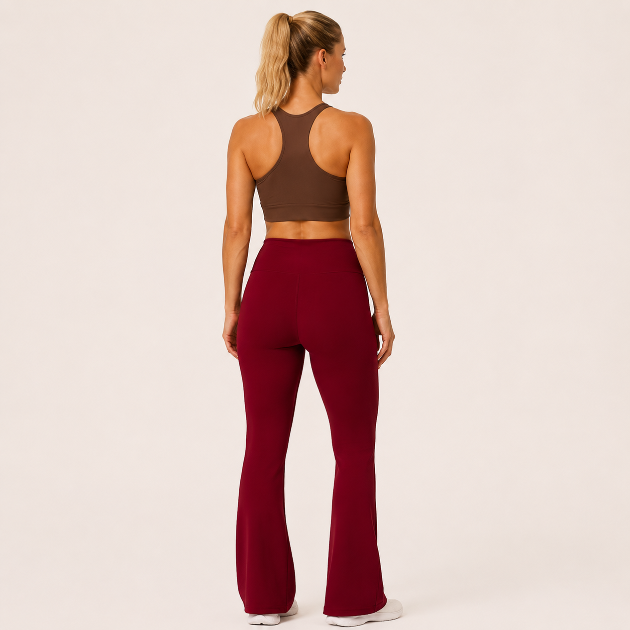 Back view of the burgundy Fitfigura Women’s Booty Boost Yoga Flare Pant, showing the sculpted rear fit and full-length flare leg.