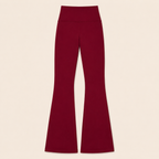 Flat lay of the Fitfigura Women’s Booty Boost Yoga Flare Pant in burgundy, showing the high waist and full-length flared leg design.