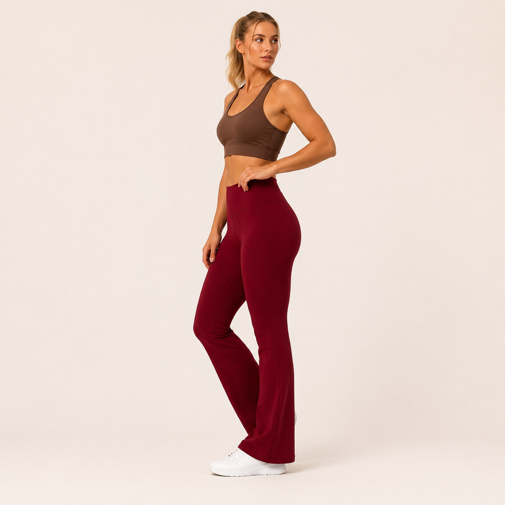 Side-angle view of the Fitfigura Women’s Booty Boost Yoga Flare Pant in burgundy, showing the sculpted waist and smooth flared silhouette.