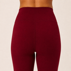 Close-up of the burgundy Fitfigura Women’s Booty Boost Yoga Flare Pant showing the high waistband and smooth contour fabric.