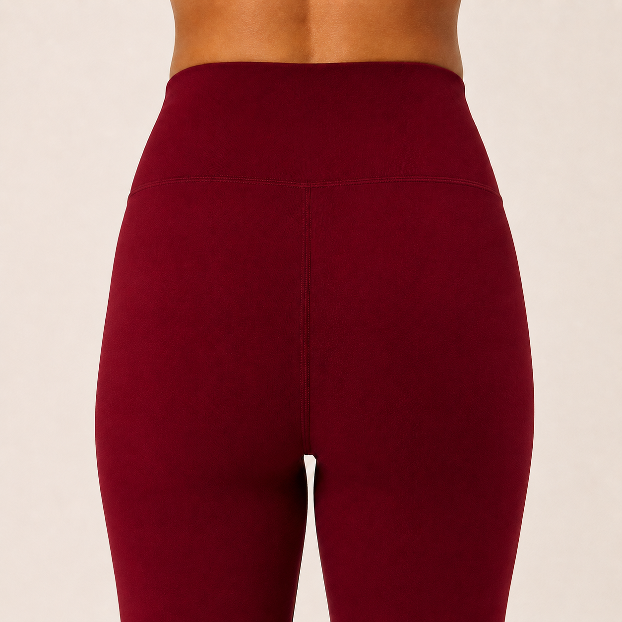 Close-up of the burgundy Fitfigura Women’s Booty Boost Yoga Flare Pant showing the high waistband and smooth contour fabric.