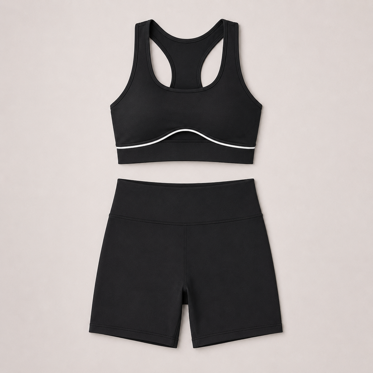 Flat lay of the black LuxeSculpt™ Active Set featuring a strappy sports bra and matching shorts.