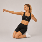 Side view of the LuxeSculpt™ Active Set with fitted black shorts and matching sports bra.