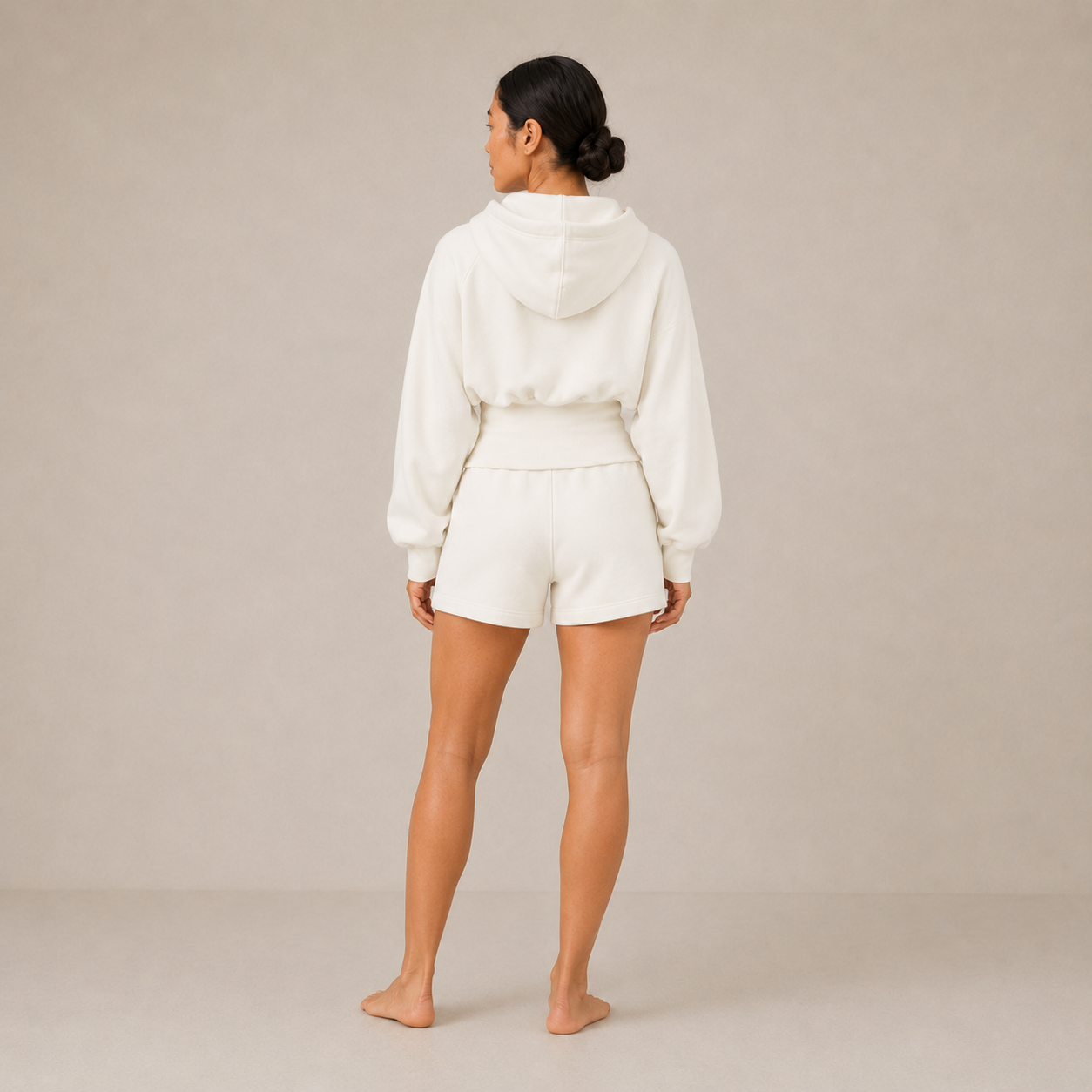 Back view of the Sculpt Hoodie – Structured Form with matching shorts, showing the hood and rear silhouette.