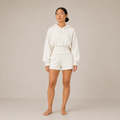 Model wearing the Sculpt Hoodie – Structured Form in white with matching shorts, shown from the front.