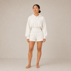 Model wearing the Sculpt Hoodie – Structured Form in white with matching shorts, shown from the front.