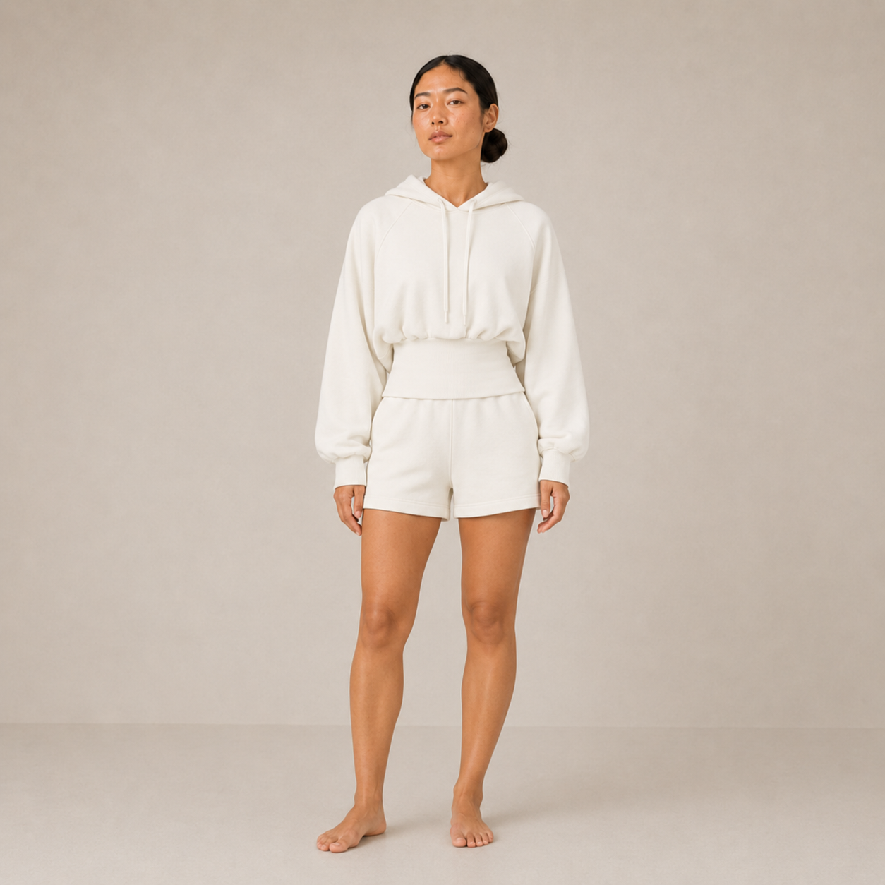 Model wearing the Sculpt Hoodie – Structured Form in white with matching shorts, shown from the front.