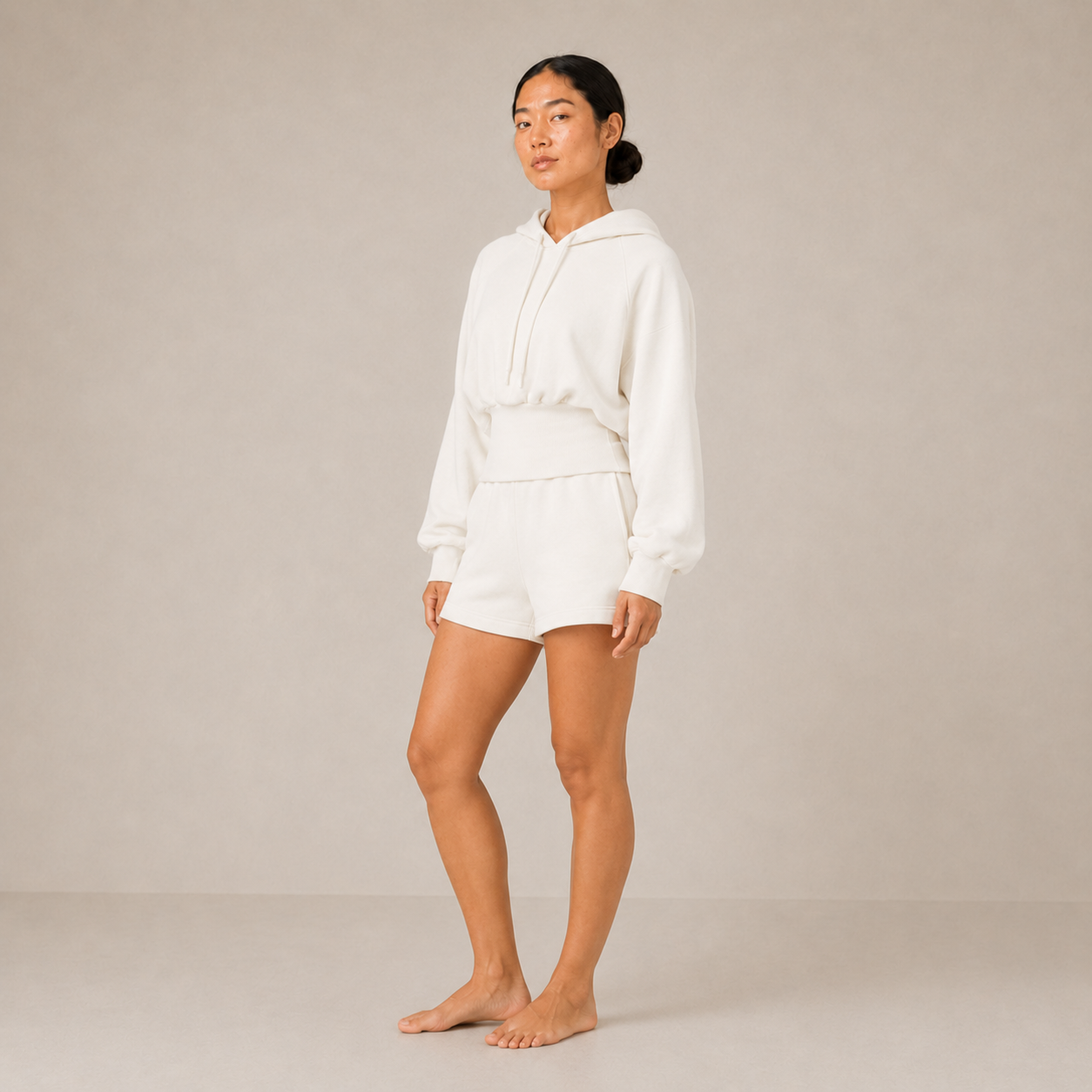 Full-body front pose of the Sculpt Hoodie – Structured Form paired with white shorts.