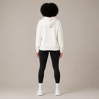 Back view of the Zip Hoodie – Utility Form paired with black leggings and white sneakers.