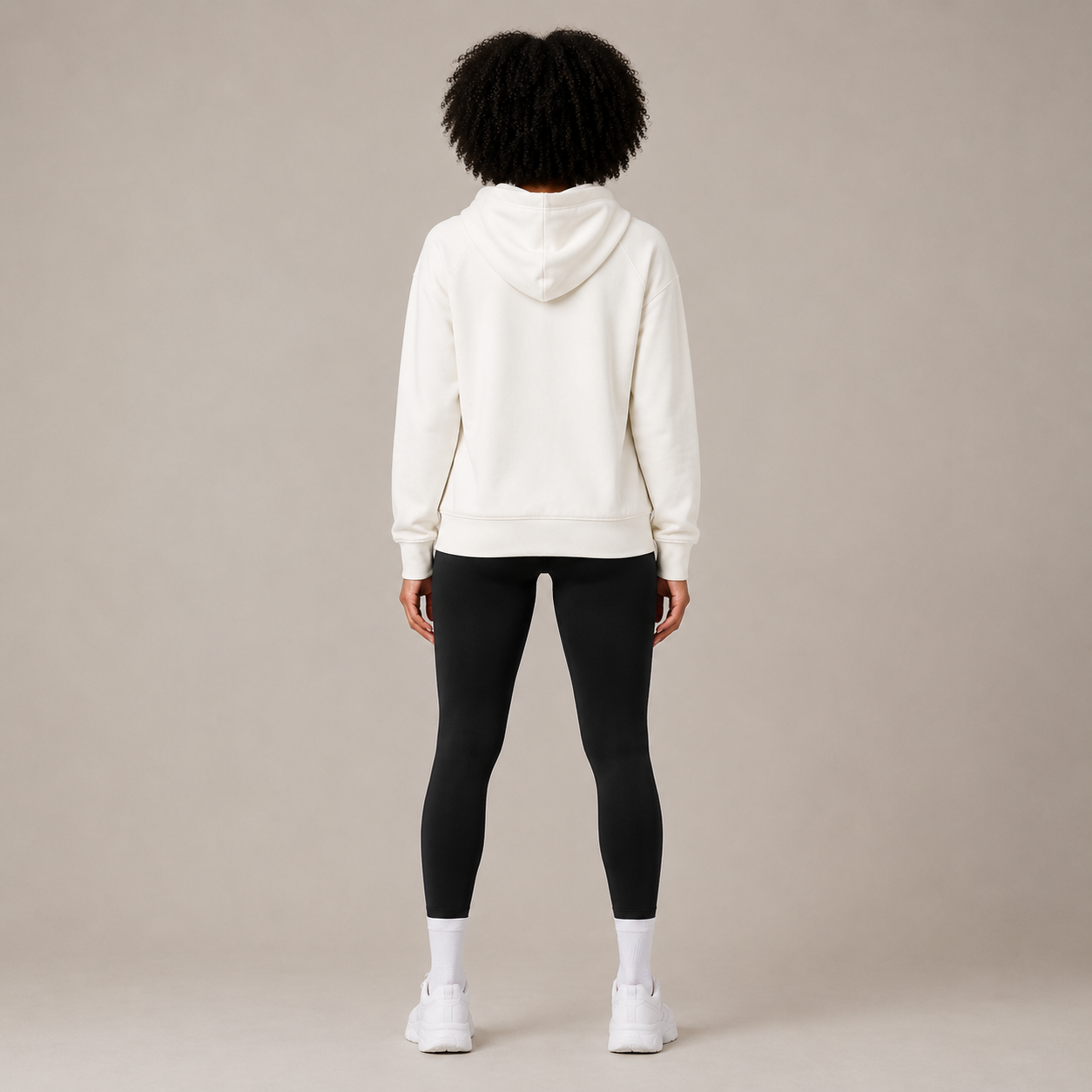 Back view of the Zip Hoodie – Utility Form paired with black leggings and white sneakers.