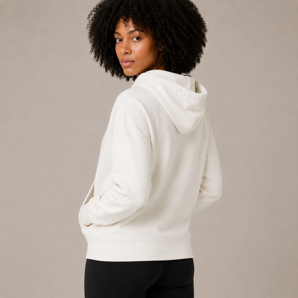 Rear angled view of the Zip Hoodie – Utility Form, highlighting the hood and smooth back silhouette.