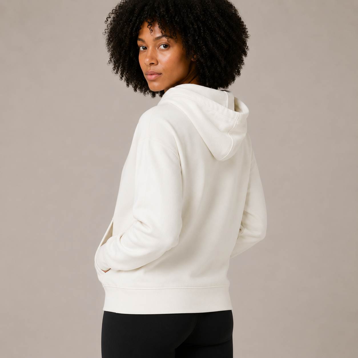 Rear angled view of the Zip Hoodie – Utility Form, highlighting the hood and smooth back silhouette.