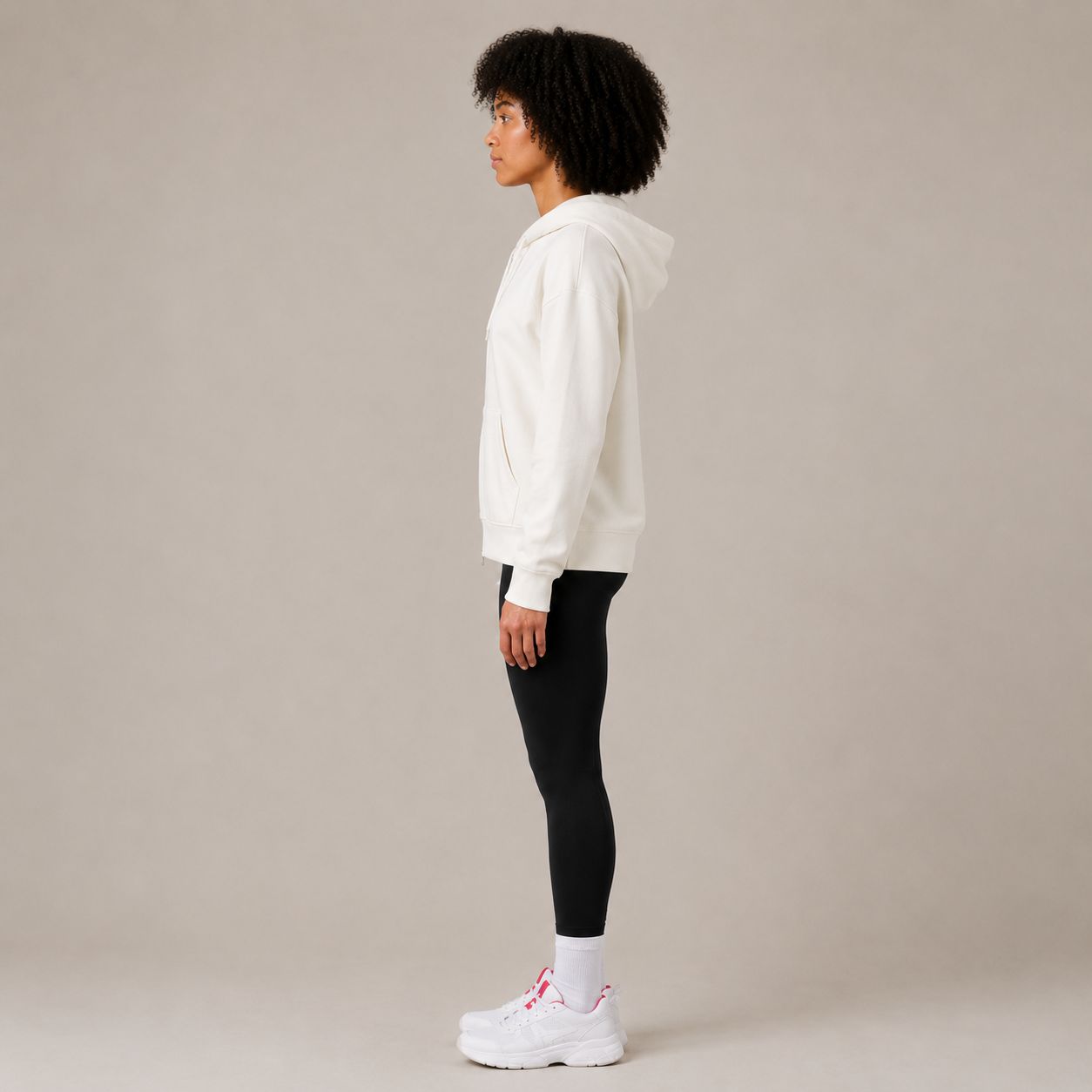 Side view of the Zip Hoodie – Utility Form showing the hood, sleeve length, and relaxed fit.
