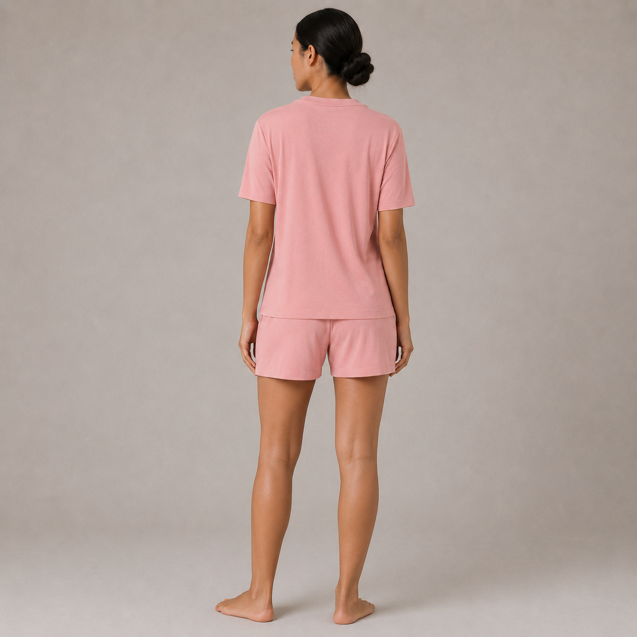 Back view of the FitFigura Sculpt LoungeWear Set in Paradise Pink, featuring a relaxed tee and matching lounge shorts.